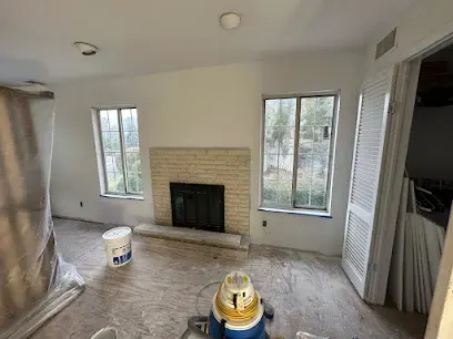 Dehumidifier and air mover drying an emptied room after water damage in a Queens home
