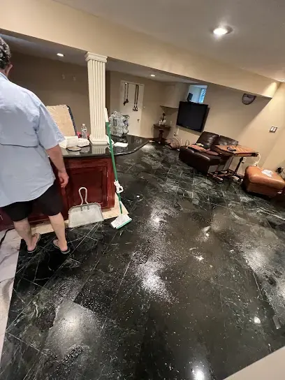 Standing water across a finished room floor waiting for extraction in an East Elmhurst home
